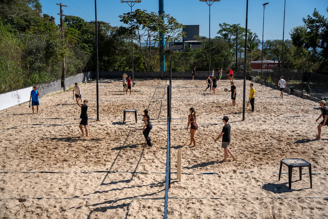 Elevated view of the sand courts with several matches at once.