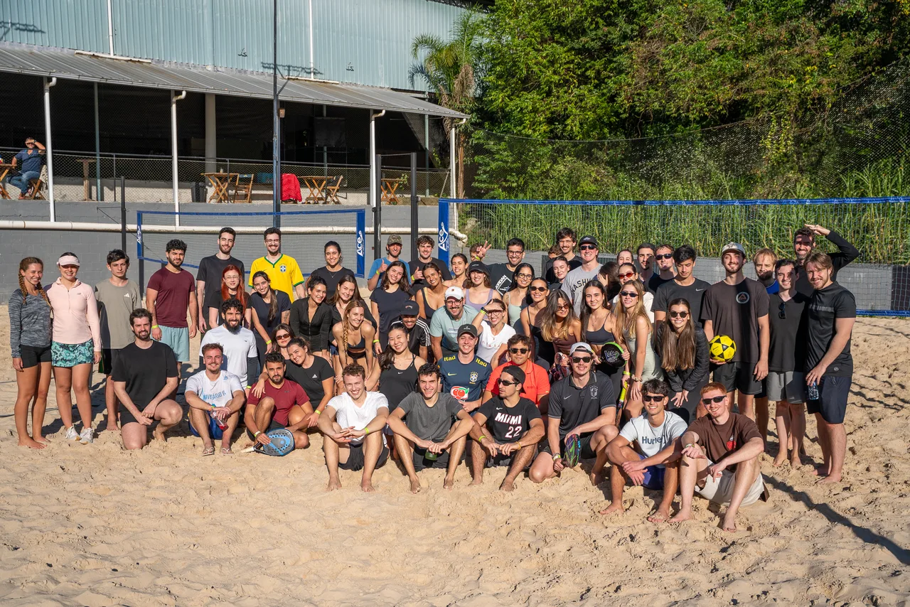Group photo of the participants on the sand courts.